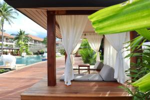 a resort deck with a bed and a pool at Bandara Spa Resort & Pool Villas, Samui in Bophut