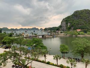 a body of water with trees and a mountain at CAT BA ROSALIA HOTEL in Cat Ba