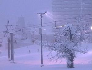 a ski lift in the snow with people on it at STI SKI LODGE in Seki