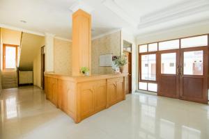 a large room with wooden cabinets and a door at SUPER OYO 3335 Wisma Langen Werdhasih in Semarang