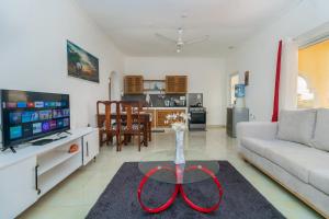 a living room with a couch and a table at Chameleon house diani in Ukunda