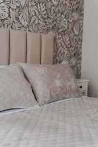 a bed with two pillows on top of it at RentWill apartments Diplomat in Chişinău