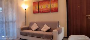 a living room with a couch with two pillows at Parri 33 Bologna Fiera 4+1 Guest Parking on demand in Bologna