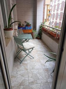 a patio with a table and a chair on a balcony at Flat in Castellon in Castellón de la Plana