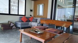 a living room with a couch and a table at An Pao Beach Residence Villa 1 - Koh Yao Noi in Ko Yao Noi