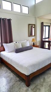 a large bed in a bedroom with skylights at An Pao Beach Residence Villa 1 - Koh Yao Noi in Ko Yao Noi