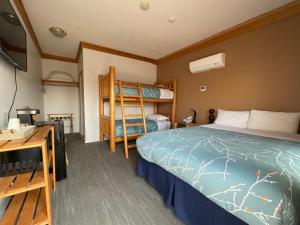 1 dormitorio con 1 cama y 1 litera en Bear's Claw Lodge, en Cache Creek