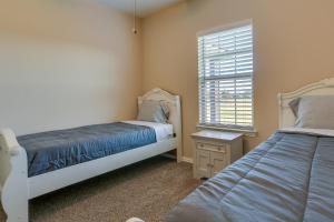 a bedroom with two beds and a window at McKinney Home with Backyard, 10 Mi to Dtwn! in McKinney