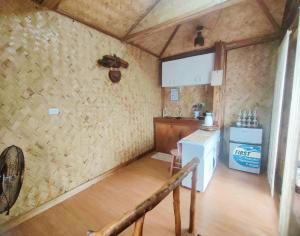 a kitchen with a counter and a stove in a room at El Nido Backpackers Guesthouse in El Nido