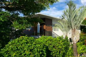 a house with a palm tree in front of it at One Hagdan Villas in Boracay