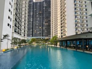 a large swimming pool in a city with tall buildings at Trefoil @ Studio Comfy~Dhomestay 2 in Shah Alam