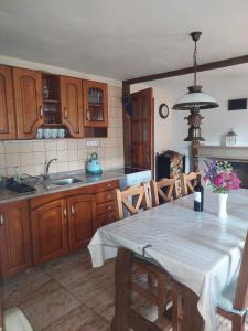 a kitchen with a table with a white table cloth on it at Burg nad Banskou Štiavnicou in Štiavnické Bane