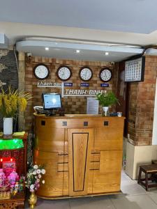 a counter with clocks on the wall in a store at Thanh Binh hotel in Ho Chi Minh City