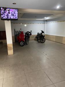 two motorcycles parked in a room with a tv at Thanh Binh hotel in Ho Chi Minh City