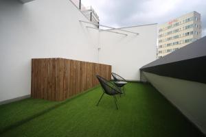 a black chair sitting on a green floor in a building at H Avenue Hotel Minam in Busan