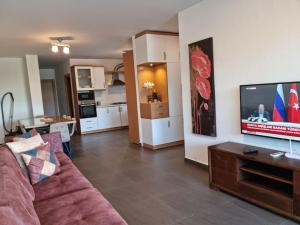 a living room with a couch and a flat screen tv at Super Luks, Denize 100 Metre, Ruya Evi 2 in Marmaris