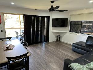 a living room with a couch and a table at Paradise Tourist Park in Tamworth