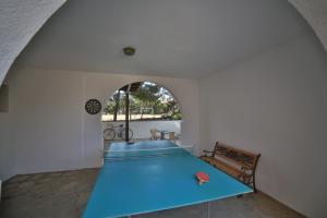 a large blue table in a room with an arch at Pirgos Naxos in Aliko Beach