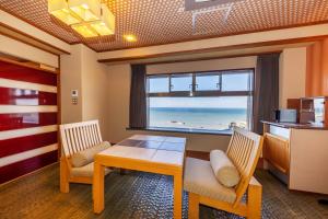 a dining room with a table and a view of the beach at 銚子グランドホテル in Choshi