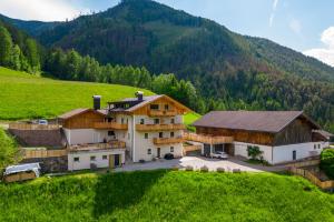 an aerial view of a house in a mountain at Planerhof Apartment Edelweiss in Funes