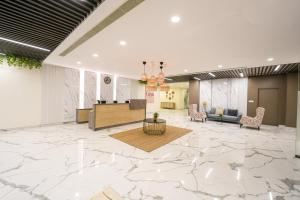 a lobby with a large marble floor and a waiting room at Casa Hotel & Suites, Gachibowli, Hyderabad in Hyderabad
