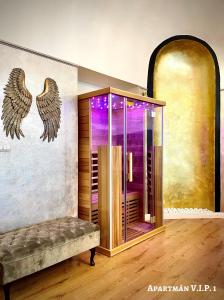 a bathroom with a shower with wings on the wall at Penzion Villa Regia in Košice