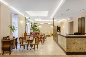 a restaurant with tables and chairs in a room at Kalvin House Budapest in Budapest