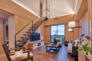a living room with a staircase in a house at Apexvilla-moon in Dongshan