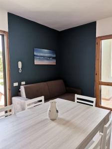 a dining room with a table and a couch at Santa Luria Casa dolce Casa in Santa Luria +38 photos