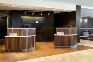 a lobby with two reception desks in a building at Courtyard by Marriott Bakersfield in Bakersfield