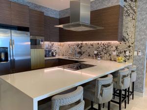 a kitchen with a island with bar stools at SOL ARENA Y MIRAMAR 