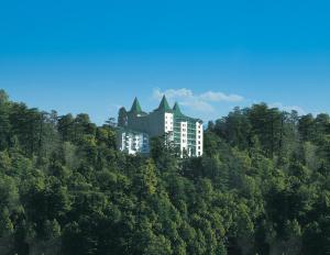 a large building with trees on top of it at The Oberoi Cecil in Shimla