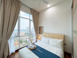 a bedroom with a bed and a large window at Paragon Suite Homestay by Antlerzone in Johor Bahru