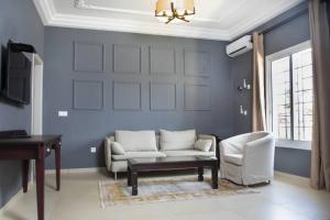 a living room with a couch and a piano at Riad Prince Louis in Yaoundé