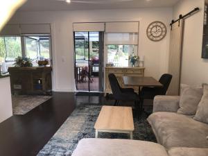 a living room with a couch and a table at Kookaburra Cottage in Bowral