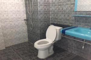 a bathroom with a toilet and a blue sink at The Hope Apartment in Ban Chang