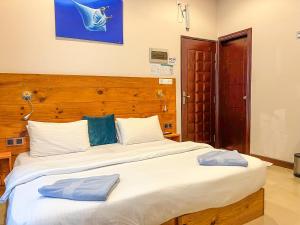 Un ou plusieurs lits dans un hébergement de l'établissement Thulusdhoo Inn
