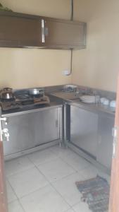 a kitchen with a stove and a counter top at Umadesa villa in Penginyahan