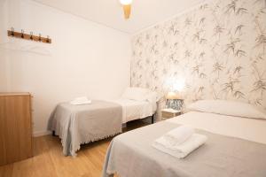 a bedroom with two beds with towels on them at Apartamento La Luz by Clabao in Denia