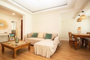 a living room with a couch and a table at Apartamento La Luz by Clabao in Denia +26 photos