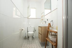 a white bathroom with a toilet and a sink at Apartamento La Luz by Clabao in Denia