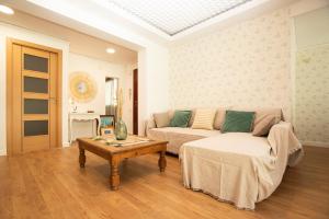 a living room with a couch and a coffee table at Apartamento La Luz by Clabao in Denia