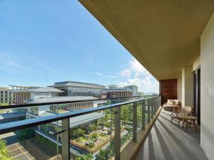 a balcony with a view of the city at Angsana Zhuhai Hengqing in Zhuhai