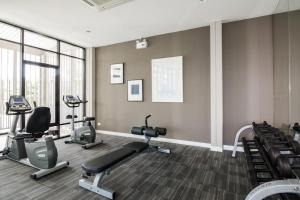 a gym with several exercise bikes and treadmills at First Choice Suites by the Sea SHA Plus Extra in Hua Hin