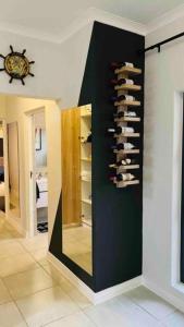 a room with a rack of shoes on a wall at BALLITO HILLS , 2 bedroom apartment in Ballito