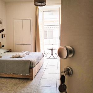 a bedroom with a bed and a door to a patio at Petracca Guest House in Monopoli