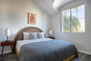 a bedroom with a large bed and a window at Century City 2br w bbq roof lounge nr mall LAX-1118 in Los Angeles