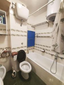 a bathroom with a toilet and a tub and a sink at Sguardo nel bosco - Appartamento - Terminillo in Terminillo