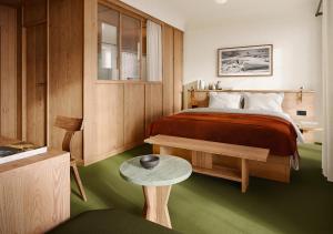 a bedroom with a bed and a table in it at Grand Hôtel Belvédère, Wengen, a Beaumier Hotel in Wengen