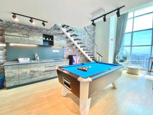 a room with a pool table in the middle of it at Maritime Suites - Pool Table FULL Seaview 2BR Duplex Suites in Jelutong